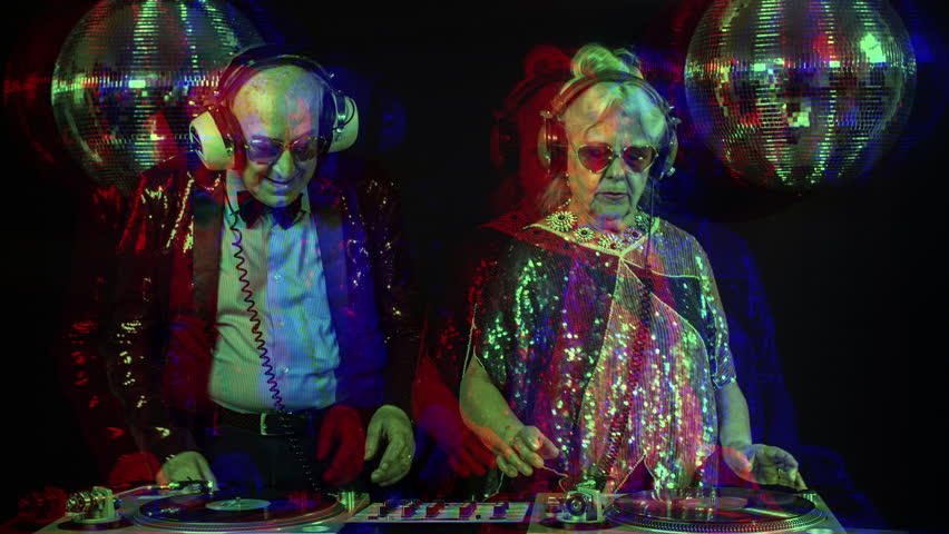 an amazing grandma and grandpa, older couple djing and partying in a disco setting. this version has overlayed video distortion and glitch effects Royalty-Free Stock Footage #33395125