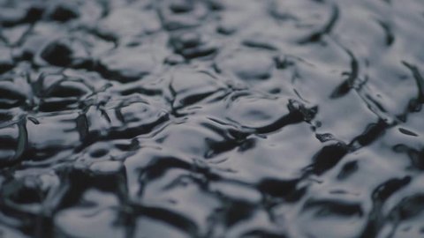 Dark Waves Vibrations and Black Water Liquid over a Subwoofer Audio Speaker