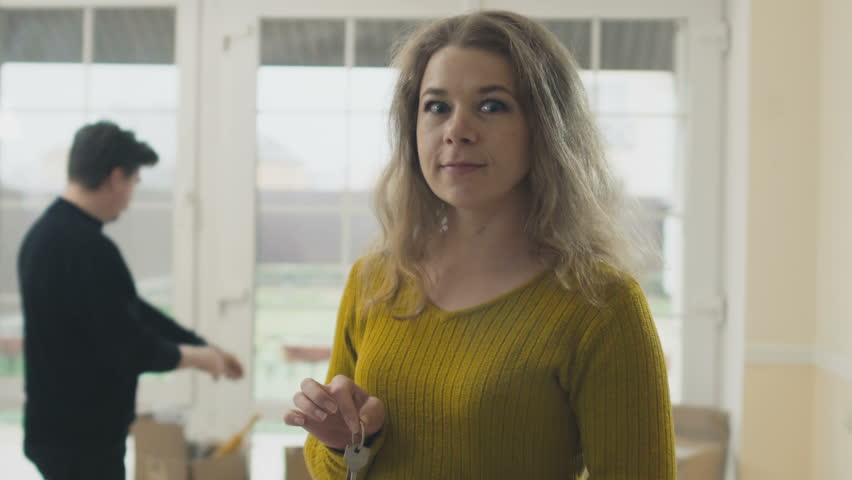 Happy woman with keys from a new house