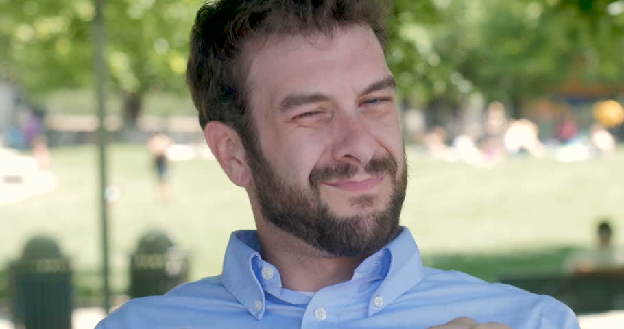 Successful confident handsome man in his early 30s looking, smiling and pointing at the camera and nodding yes