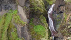 Picturesque landscape of a mountain waterfall and traditional nature of Iceland. HD Footage.