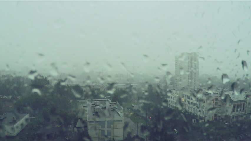 Rain drops on the window and city outside