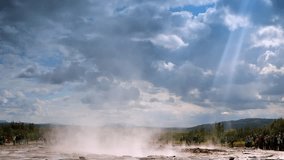 Icelandic geyser vapors and picturesque nature with moving tourist. HD Footage.