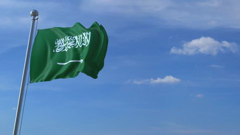 Airplane flying over waving flag of Saudi Arabia