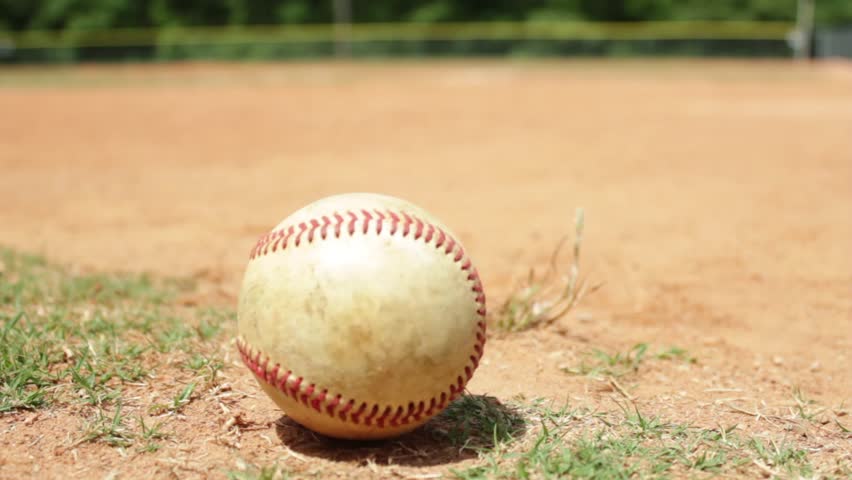 Close up shot of a baseball on a baseball diamond