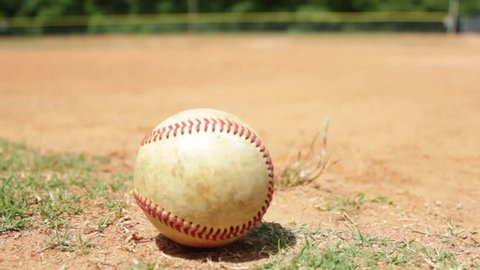 Close up shot of a baseball on a baseball diamond