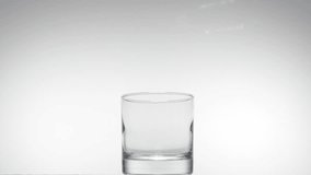 Pouring glass of water in slow motion on white background. fullHD video shot at 250fps