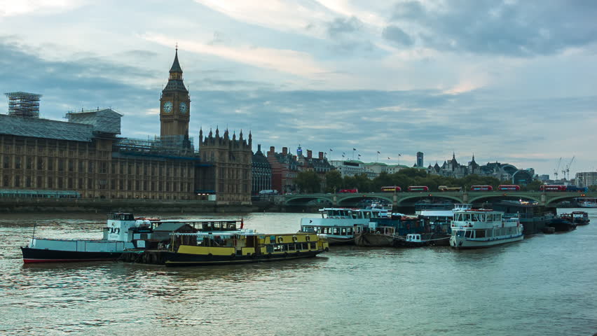 Time-Lapse of the Big Ben in London, Westminster.
Blue clouds with reflections on the river Thames. Yellow evening and night lights. 
Busy London from a much calmer perspective.