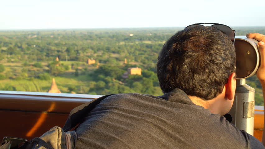 Man Viewing Bagan Temples in Myanmar through Binoculars