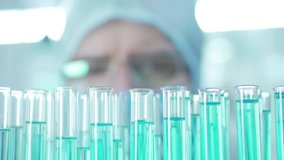 a lab technician takes a sample of fluid from a test tube - Powered by Shutterstock - Get 15% off with code: PIKWIZARD15