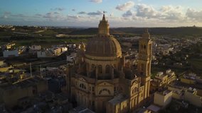 4k aerial drone footage - Sunrise over Rotunda St. John Baptist Church at sunrise.  Located in Xewkija, Gozo.  Country of Malta.  