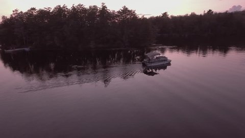 Flying around pontoon boat on lake McKellar at sunset. 