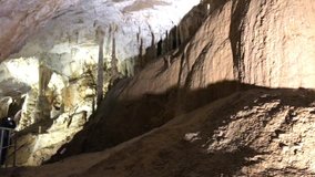 Cave formations of stalactites and stalagmites slow tilt 1920X1080 HD footage - Area deep inside underground cavern 1080p FullHD tilting  video