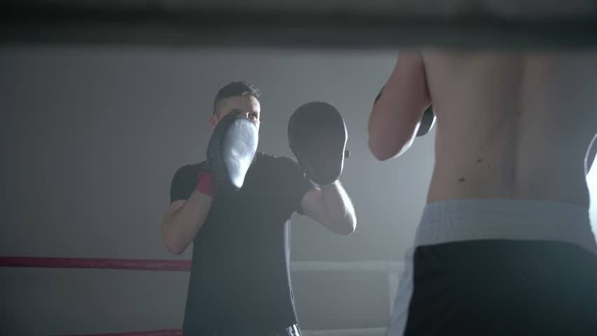 Two men training in a boxing ring