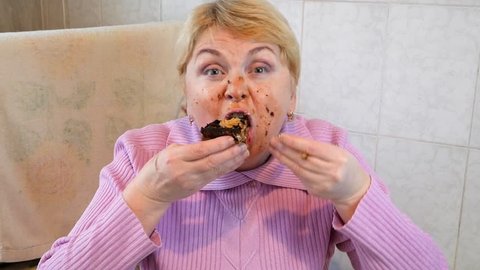 Funny woman enjoy sweets and cake. Video. glutton woman is eating