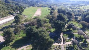 Aerial bird's eye view video taken by drone of archaeological site of Ancient Olympia, Peloponnese, Greece
