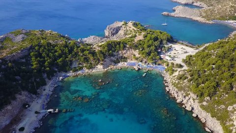 Summer 2017: Aerial bird's eye view video taken by drone of famous beach of Anthony Quinn with clear water rocky seascape, Rhodes island, Greece