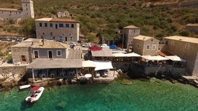 Summer 2016: Aerial birds eye view video taken by drone of famous picturesque village of Limeni with turquoise clear waters, Peloponnese, Greece