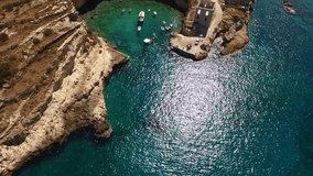 Aerial birds eye view video taken by drone of fishing village of Mezapos with green clear waters, Mani, Laconia, Peloponnese, Greece