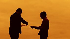 businessman discussion sunset silhouette sunlight standing evil boss clipboard concept. two businessman men swearing outdoors conflict fight looking at slow motion video