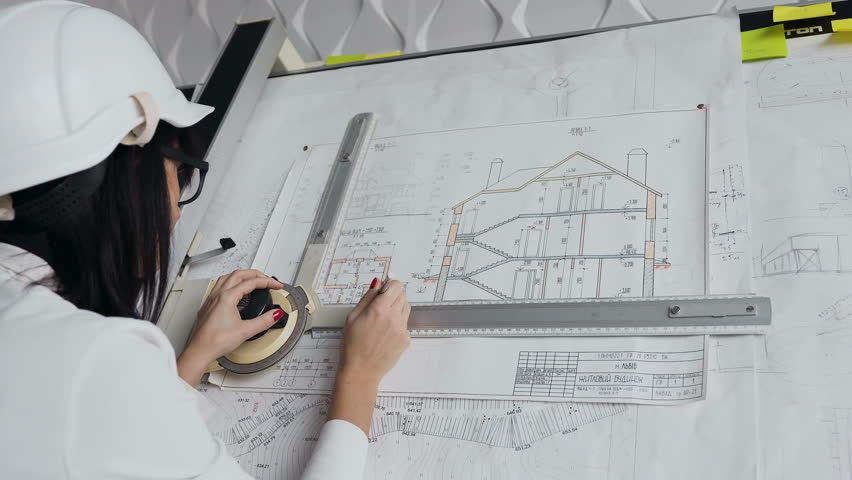 Close-up. Young female architect working on drawing device a blueprint project of new residential building. Concept of work on technical drawings 4k Royalty-Free Stock Footage #33499366