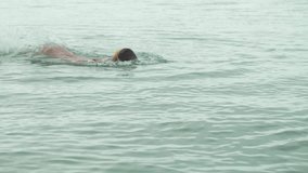 Young girl in sports glasses is floating in the sea stock footage video