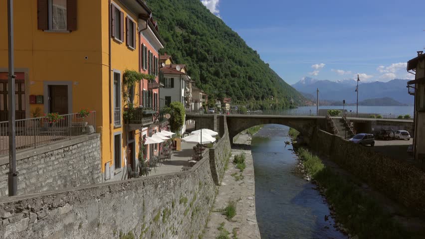 Multicolored houses in the town on the shore of Lake Como, Lombardy, Italy, panorama 4k