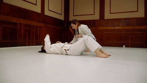 Fight. Girls train for training in judo and jujitsu
