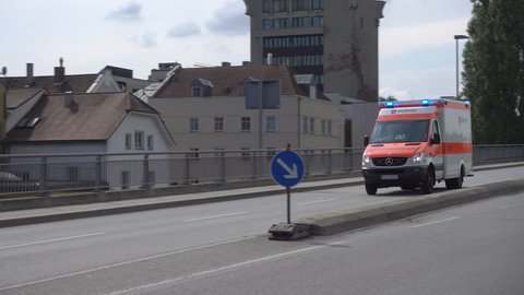 PASSAU, BAVARIA/GERMANY - SEPTEMBER 09, 2017: Emergency ambulance with siren and lights flashing. The development of ambulance services in Germany started in the late 19th century.