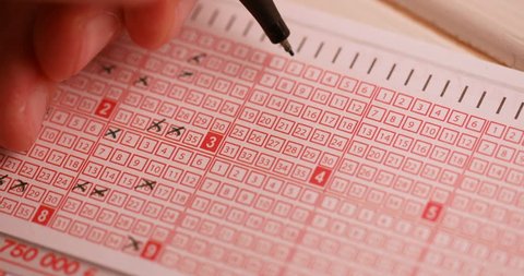 fill out a lottery ticket hand with pen cross out numbers