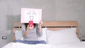 woman take smile board and selfie on the bed