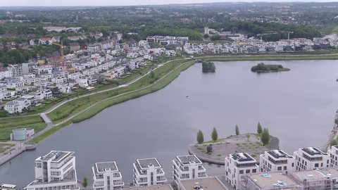 Aerial Drone moving sideways forwards over Phoenix lake in Dortmund Germany 4k