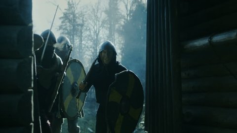 Large-Scale Medieval Battle Reenactment. Violent Tribe of Warriors Run Through The Gates of the Wooden Fortress and Attack Guards. They Fight with Axes, Swords and Shields.  Shot on RED EPIC-W 8K.