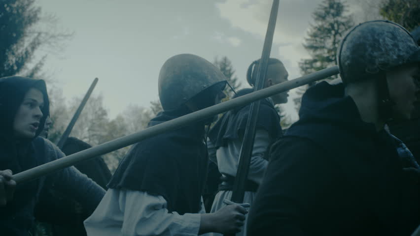 Large-Scale Medieval Battle Reenactment. Violent Tribe of Warriors Attack Wooden Fortress Wall, They Climb Ladders, Guards Try to Defend Fortification. Shot on RED EPIC-W 8K Helium Cinema Camera. Royalty-Free Stock Footage #33523444