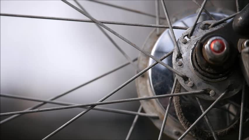 View through a spoked bicycle wheel, very structural because of the spokes, 
