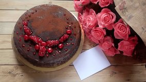 Big chocolate cake and beautiful bunch of pink roses