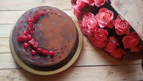 Big chocolate cake and beautiful bunch of pink roses