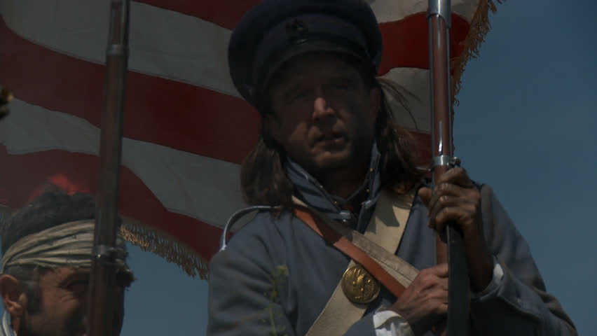 MEXICO - SUMMER 2017 - Mexican-American War anniversary reenactment -- before battle.  Several American Soldiers stand atop earthen fortress, with American flag and muskets in hot summer mexican sun.