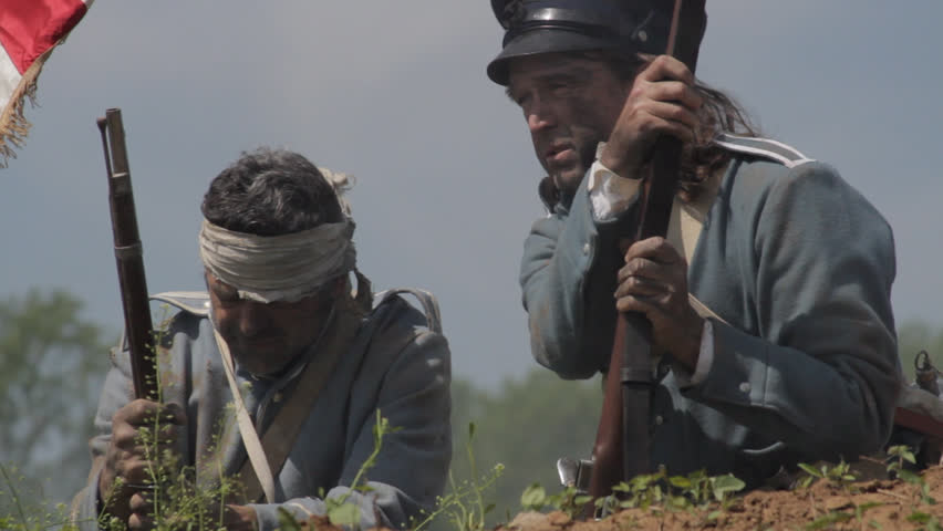 MEXICO - SUMMER 2017 - Mexican-American War anniversary reenactment -- before battle.  Several American Soldiers stand atop earthen fortress, with American flag and muskets in hot summer mexican sun.