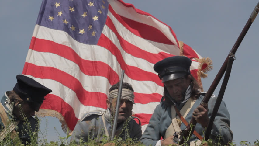 MEXICO - SUMMER 2017 - Mexican-American War anniversary reenactment -- before battle.  Several American Soldiers stand atop earthen fortress, with American flag and muskets in hot summer mexican sun.
