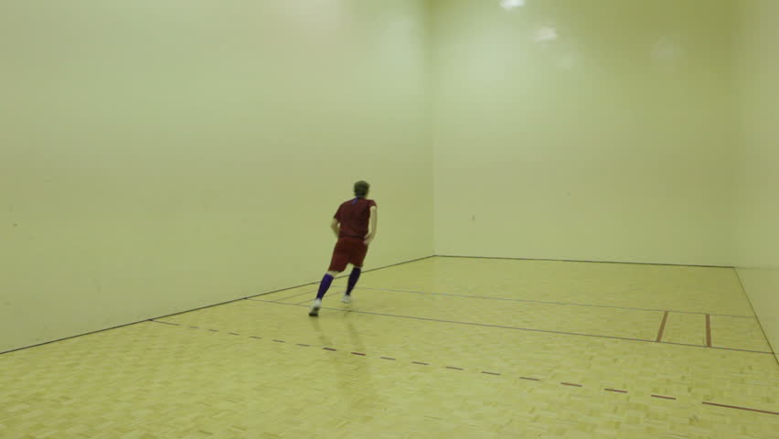 Playing racquet ball. College student boys playing racketball in competition together. In door fitness sport of racquetball.
