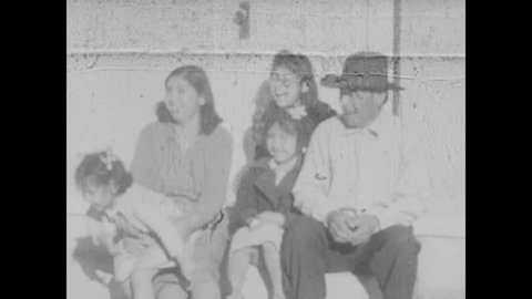 1930s: Paiute family in church clothes wait outside Methodist Church. Old men and women in kerchiefs and hats wait.