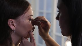 Lash maker increases eyelashes, make up artist making long lashes, woman in beauty studio makes evening make up