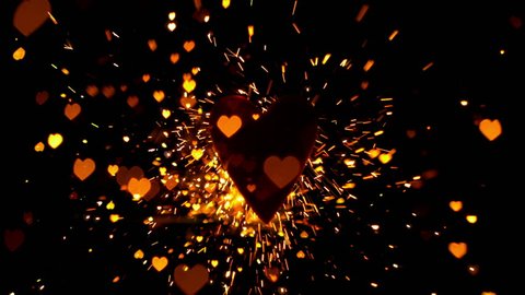 Golden confetti and sparks flying against heart in slow motion
