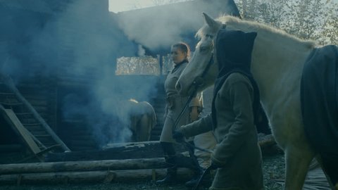 Medieval Reenactment. Life in the Yard of the Wooden Fortress, People with Horses. Shot on RED EPIC-W 8K Helium Cinema Camera.