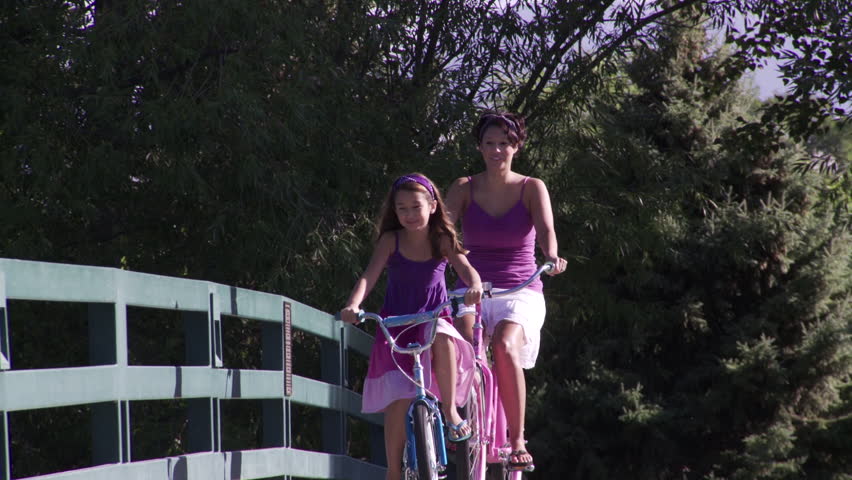 Woman girl ride over bike bridge crossing Boise River