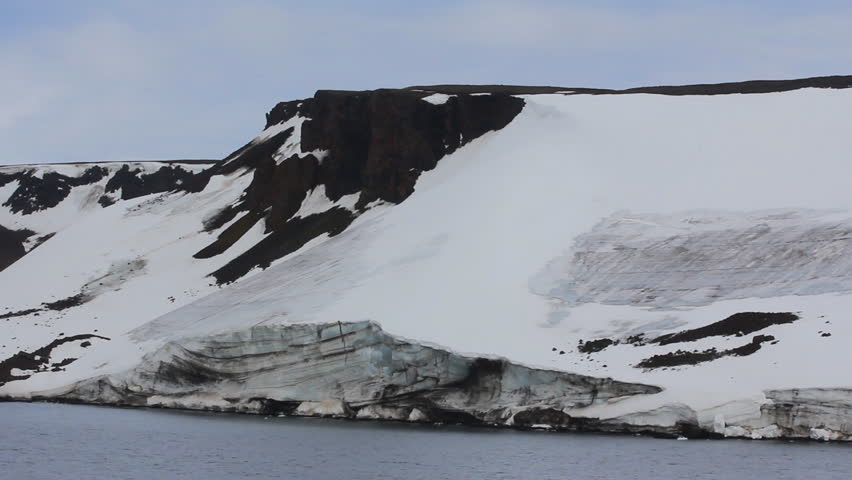 Aviation operations in the high Arctic. Landing helicopter on shore of island Hooker, among snowfields and glaciers. Franz Joseph Land