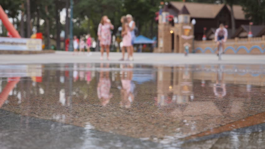 Braking on a bicycle in wet surface. Young man riding a vintage bicycle at the park. Sporty guy cycling outdoor. Healthy active lifestyle. Front view Close up Slow motion