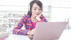 woman student listen music and use notebook in the libray