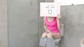 woman take smile billboard in the toilet